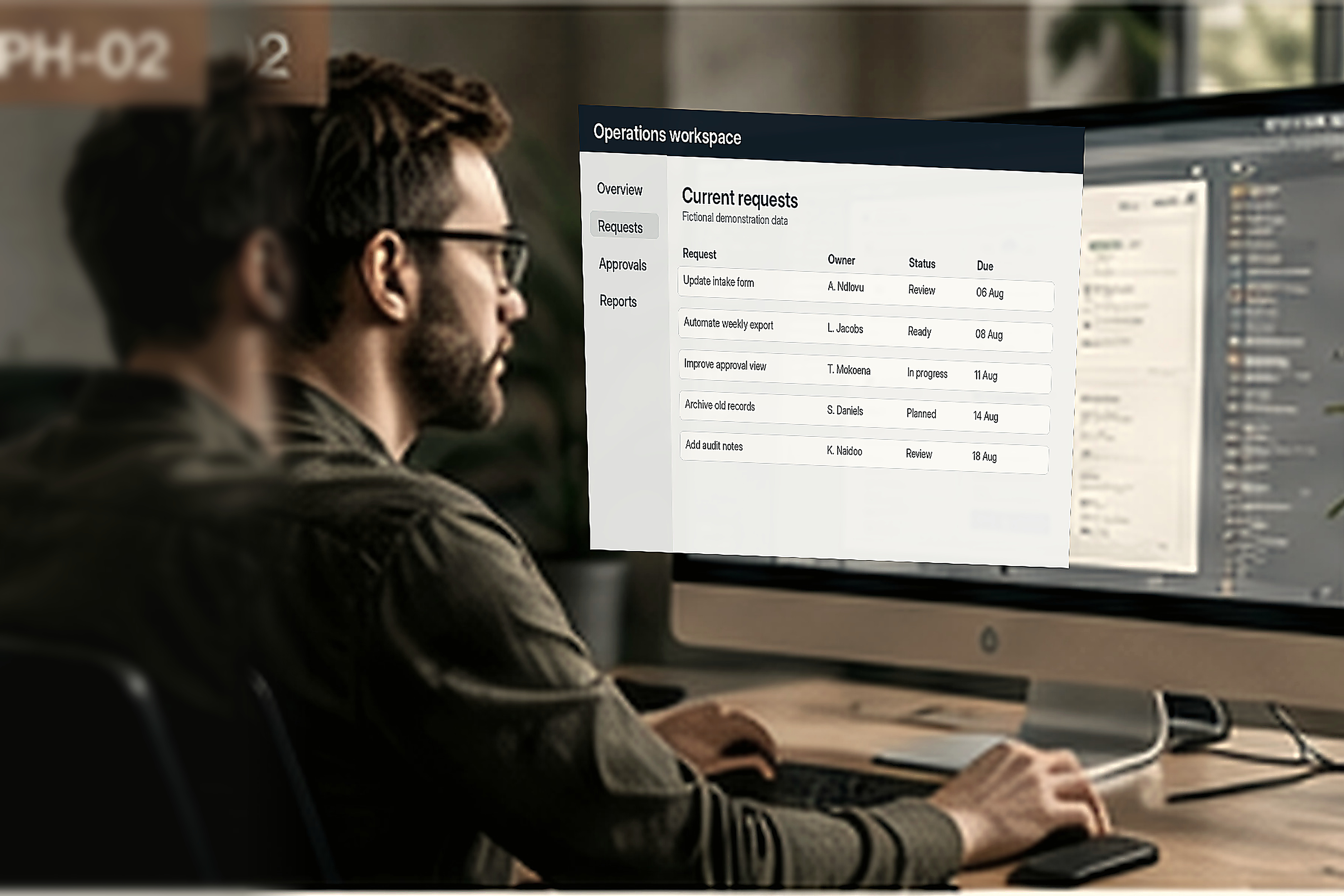 A person uses a purpose-built application at a workstation, with staged non-client content on screen.